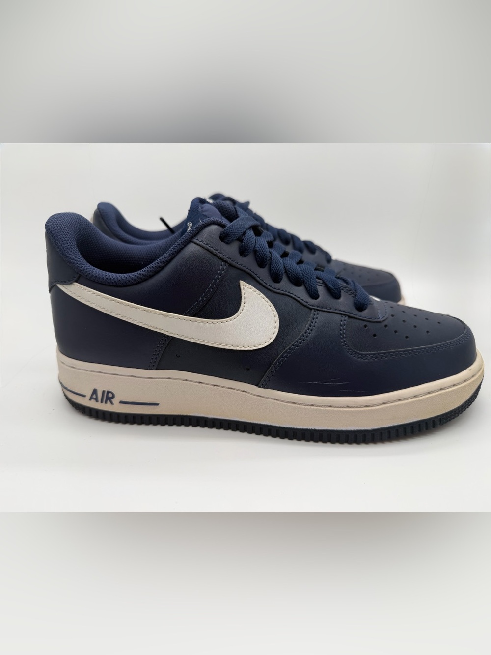 Nike Men’s Air Force OnesNavy and White Low-Top Sneakers — Leather Swoosh Detail